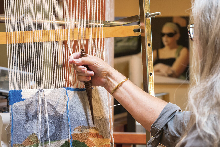 At home in her studio, Macdonald weaves a  a tapestry on her loom.